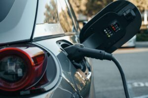 Close-up of an electric vehicle being charged, highlighting modern clean energy technology.
